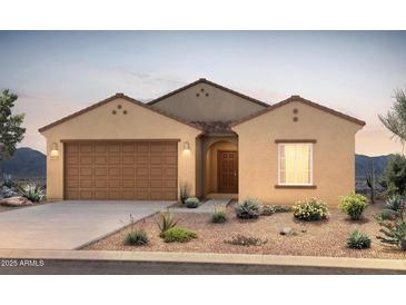 Beautiful desert home with a two-car garage, landscaped yard, and stucco exterior at 5091 S 251St Dr, Buckeye, AZ 85326