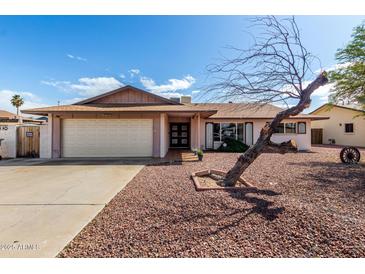 Charming single-story home featuring a well-manicured front yard with desert landscaping at 5203 W Acoma Dr, Glendale, AZ 85306