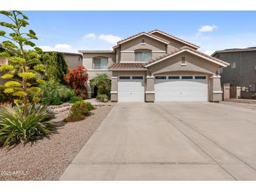 Charming two-story home with a three-car garage, beautiful desert landscaping, and a spacious driveway at 824 E Chelsea Dr, San Tan Valley, AZ 85140