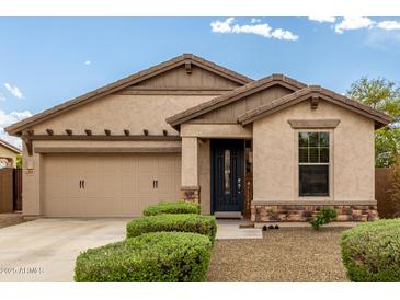 Charming single-story home features a two-car garage, well-kept landscaping, and a welcoming front porch at 12057 W Ashby Dr, Peoria, AZ 85383