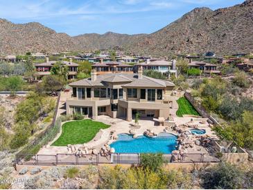 Stunning home features a rock-lagoon pool, spa, and mountain views in a desert landscape at 12639 N 136Th St, Scottsdale, AZ 85259