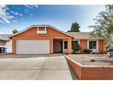 Charming single-story home with an attached two-car garage and a well-manicured front yard at 19645 N 3Rd Ave, Phoenix, AZ 85027