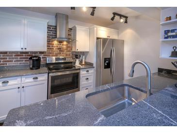 Updated kitchen features granite counters, stainless steel appliances and breakfast bar at 2146 W Isabella Ave # 154, Mesa, AZ 85202