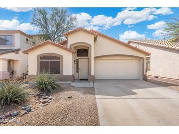 Charming single-story home featuring a two-car garage and desert landscaping for low maintenance at 2523 W Running Deer Trl, Phoenix, AZ 85085