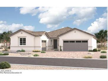 Charming single-story home featuring a spacious two-car garage and desert landscaping for low maintenance at 4740 W Capistrano Ave, Laveen, AZ 85339