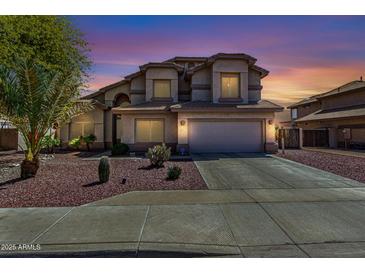 Inviting home featuring desert landscaping, a two-car garage, and a well-maintained lawn at 639 N 110Th Pl, Mesa, AZ 85207