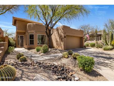 Charming southwestern home with desert landscaping, beautiful cacti and a well-maintained yard at 9653 E Sidewinder Trl, Scottsdale, AZ 85262