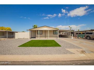 Charming single-story home featuring a cozy covered carport, low-maintenance landscaping, and a gravel yard at 1064 S 97Th St, Mesa, AZ 85208
