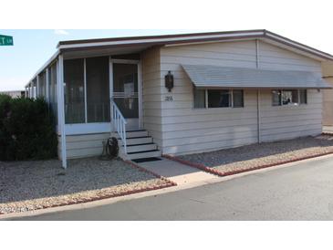 Charming home with a welcoming screened-in porch and well-maintained gravel landscaping at 11596 W Sierra Dawn Blvd # 286, Surprise, AZ 85378