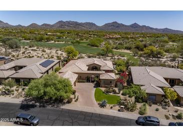 Stunning desert home with lush landscaping, mountain views, and a paver driveway at 21397 N 78Th St, Scottsdale, AZ 85255