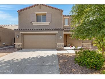 Beautiful two-story home with a two car garage and well manicured landscaping at 25457 W Clanton Ave, Buckeye, AZ 85326