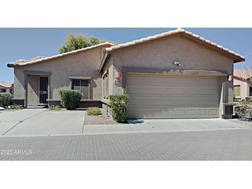 Charming single-story home features a two-car garage, desert landscaping, and a tile roof at 2600 E La Costa Dr, Chandler, AZ 85249