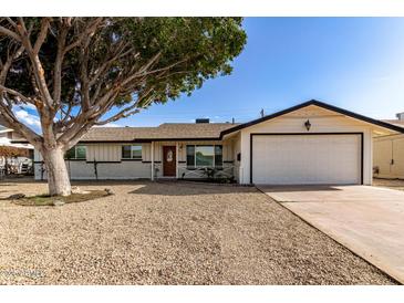 Charming single-story home with a well-maintained front yard and an attached two car garage at 3733 W Flynn Ln, Phoenix, AZ 85019