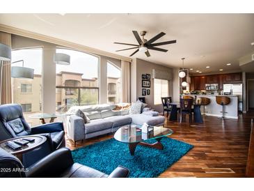 Open concept living room with a couch, hardwood floors, and views at 5350 E Deer Valley Dr # 4239, Phoenix, AZ 85054