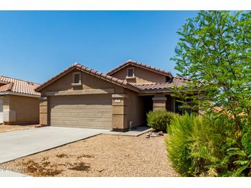 Charming single-story home with a two-car garage, tile roof, and a low-maintenance desert landscape at 672 S Porter St, Gilbert, AZ 85296