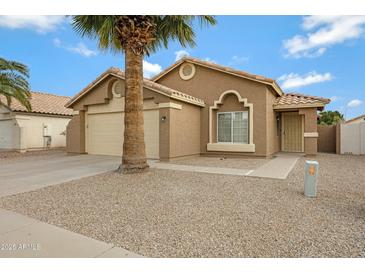 Charming single-story home with desert landscaping and a spacious two-car garage at 881 W Saragosa St, Chandler, AZ 85225