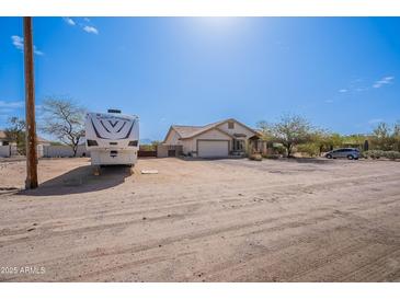 Spacious single-story home with a well-maintained front yard and an RV in the drive at 907 N Mountain Rd, Mesa, AZ 85207