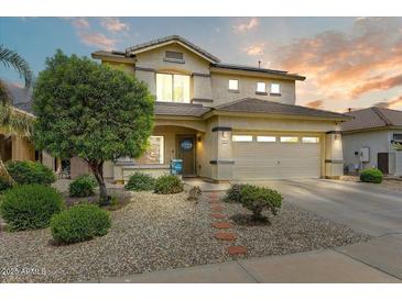 Charming two-story home boasts a well-maintained landscaped front yard and inviting curb appeal at 14554 W Evans Dr, Surprise, AZ 85379