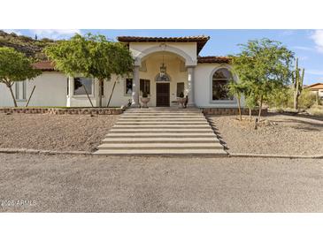 Stunning front exterior of a two-story home with a grand entrance, beautiful landscaping, and a concrete staircase at 1500 N Crismon Rd, Mesa, AZ 85207