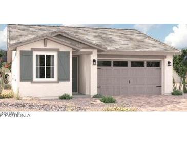 Charming single-story home featuring a neutral color palette, two-car garage, and desert landscaping at 16992 W Winston Dr, Goodyear, AZ 85338