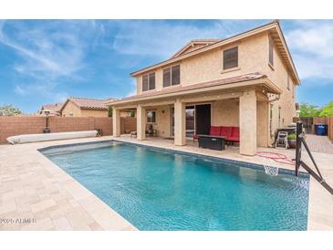 Exterior of home showcasing a large swimming pool, covered patio and second story view at 2425 E Flintlock Dr, Gilbert, AZ 85298