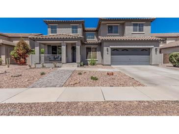 Charming two-story home with a well-maintained front yard and a two-car garage at 3528 E Tonto Dr, Gilbert, AZ 85298