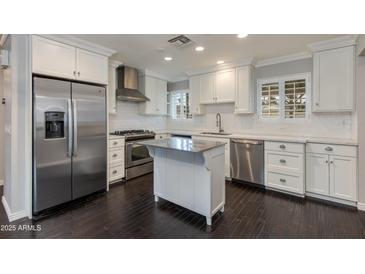 Modern kitchen featuring stainless steel appliances, white cabinetry, and a center island at 4201 N 35Th St, Phoenix, AZ 85018