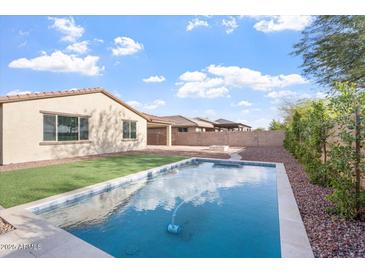 Sparkling pool is surrounded by desert landscaping, green grass and ample space for outdoor enjoyment at 4360 N 186Th Ln, Goodyear, AZ 85395