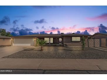 Charming single-story brick home featuring a two-car garage and low maintenance desert landscaping at 6722 E El Paso St, Mesa, AZ 85205