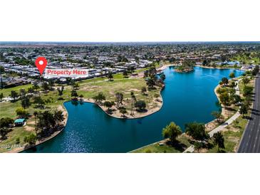 Beautiful aerial view of the property near a lake and lush green park at 8113 E Vista Dr, Scottsdale, AZ 85250