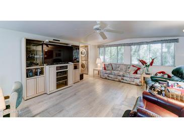 Spacious living room features a large entertainment center and bright natural light at 111 S Greenfield Rd # 670, Mesa, AZ 85206