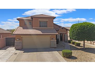 Charming two-story home featuring a two-car garage, landscaped yard, and a well-maintained exterior at 11183 W Tonto St, Avondale, AZ 85323