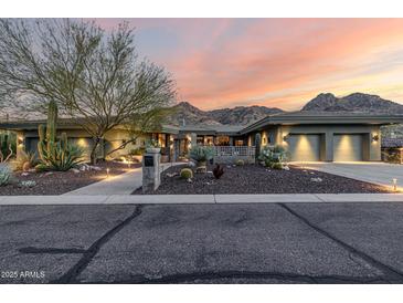 Stunning single-story home featuring desert landscaping, a three-car garage, and mountain views at 11935 E Casitas Del Rio Dr, Scottsdale, AZ 85255