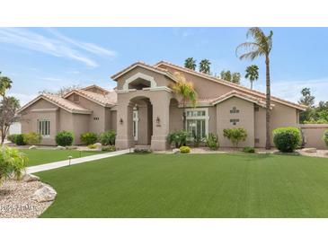 Charming single-story home with well-manicured lawn and desert landscaping at 1405 W Caribbean Ln, Phoenix, AZ 85023
