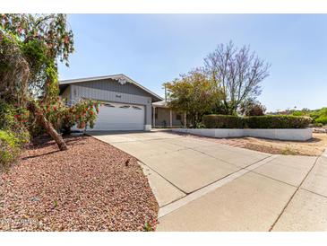 Charming single-story home featuring an attached two-car garage and mature landscaping at 1837 E Presidio Rd, Phoenix, AZ 85022