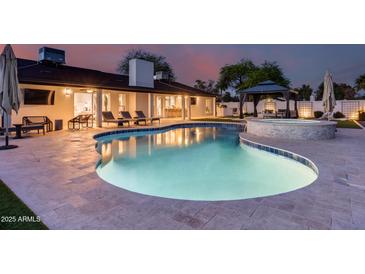 Beautiful backyard pool area with ample lounge space, a covered patio, and a luxurious gazebo, perfect for outdoor relaxation at 5975 E Larkspur Dr, Scottsdale, AZ 85254