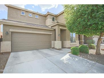 Two-story home with a neutral color scheme, well-maintained landscaping, and an attached two-car garage at 6749 W Charter Oak Rd, Peoria, AZ 85381
