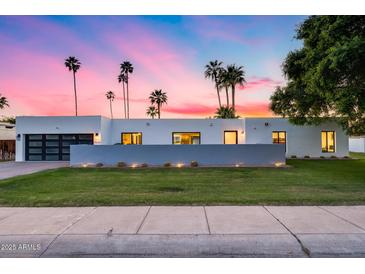 Modern home exterior showcasing sleek design, desert landscaping, and a stylish garage door at 7820 N 5Th Ave, Phoenix, AZ 85021