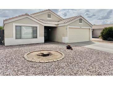 Charming single-story home with a low maintenance desert landscape and attached two-car garage at 1005 W 19Th Ave, Apache Junction, AZ 85120