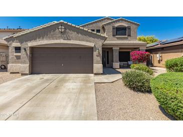 Charming two-story home featuring a two-car garage, desert landscaping, and a welcoming front porch at 15604 N 173Rd Ln, Surprise, AZ 85388