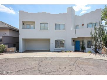 Contemporary two-story home with a striking white exterior, two-car garage and drought-tolerant landscaping at 1731 E Evans Dr, Phoenix, AZ 85022