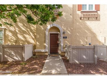 Inviting front entrance with a charming archway and well-maintained walkway at 2754 S Sulley Dr # 103, Gilbert, AZ 85295
