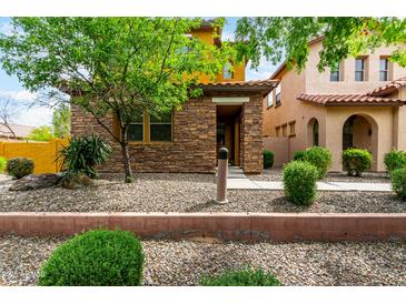 Charming two-story home featuring a stone facade and low maintenance desert landscaping at 5436 W Chisum Trl, Phoenix, AZ 85083