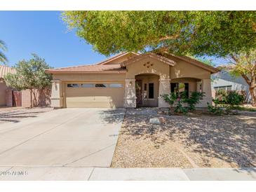 Charming single-story home with desert landscaping, covered entry, and a two-car garage at 1072 E Jade Dr, Chandler, AZ 85286