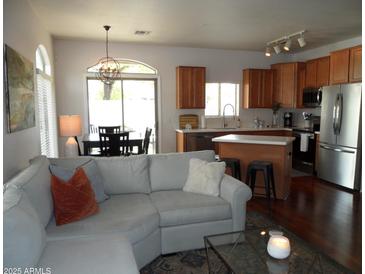 Open concept living room flows into kitchen with stainless appliances and cozy couch at 2401 E Rio Salado Pkwy # 1225, Tempe, AZ 85288
