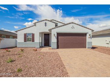 Charming single-story home with a two-car garage, paver driveway, and low-maintenance desert landscaping at 24356 W La Salle St, Buckeye, AZ 85326