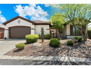 Charming single-story home featuring desert landscaping and a neutral color palette at 41817 N Bridlewood Way, Phoenix, AZ 85086