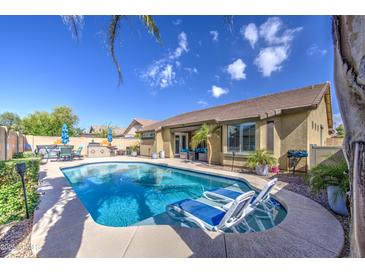 Sparkling pool with lounge chairs and outdoor dining area, perfect for relaxing and entertaining at 737 W Desert Valley Dr, San Tan Valley, AZ 85143