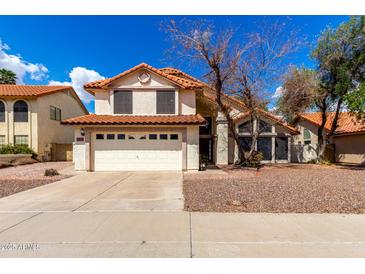 Charming two-story home featuring a tile roof, two-car garage, and desert landscaping at 7402 W Kerry Way, Glendale, AZ 85308