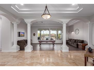 Spacious game room featuring a pool table, comfortable seating, and large windows at 16465 W Mohave St, Goodyear, AZ 85338